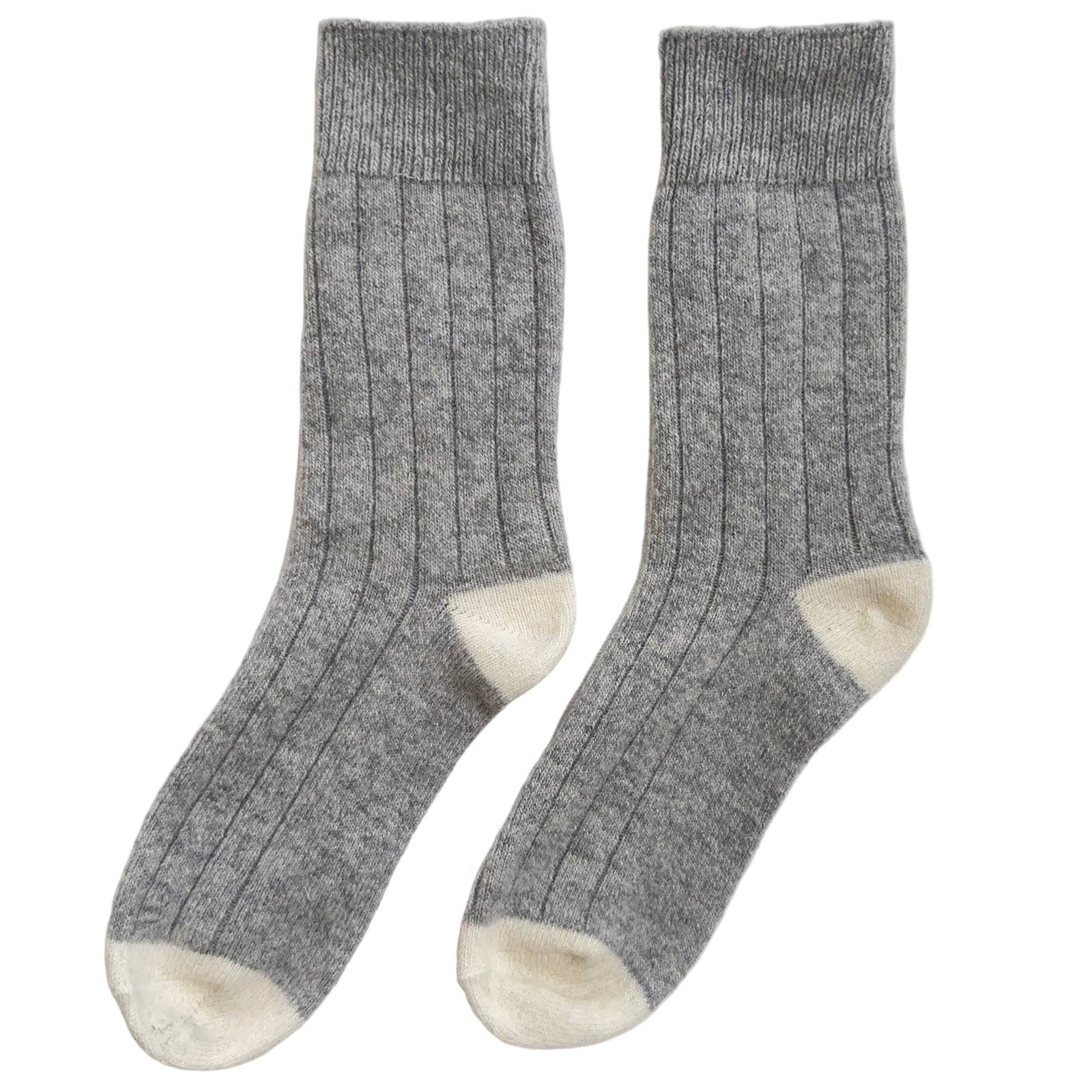 Pair of gray socks with white toes and cuffs on a light gray background