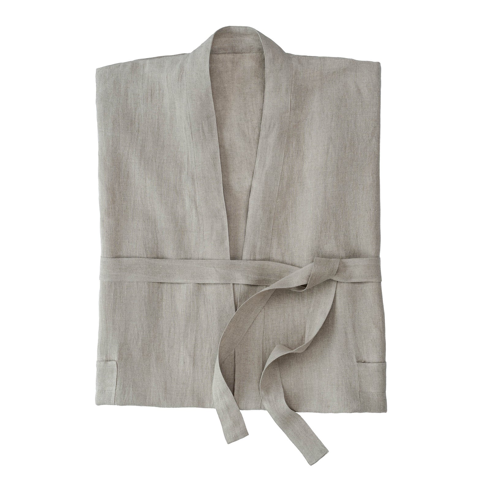 Woman wearing a beige robe against a plain background