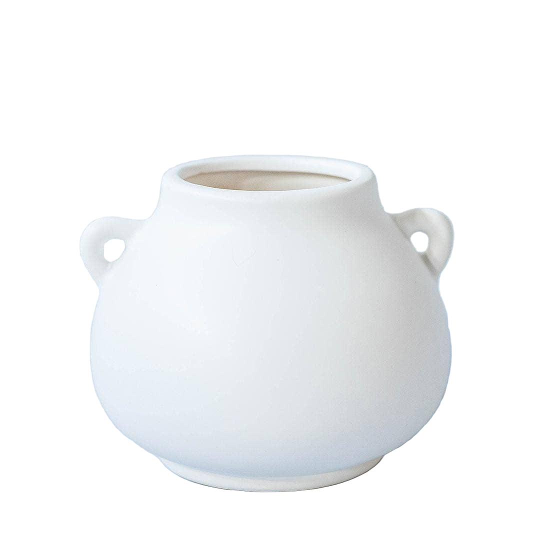 White ceramic vase with two handles on a light blue background