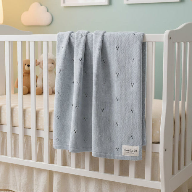 Folded gray baby blanket with 'Bleu La La Organics' label on a white background