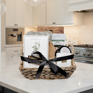 Gift basket with a black ribbon on a kitchen counter