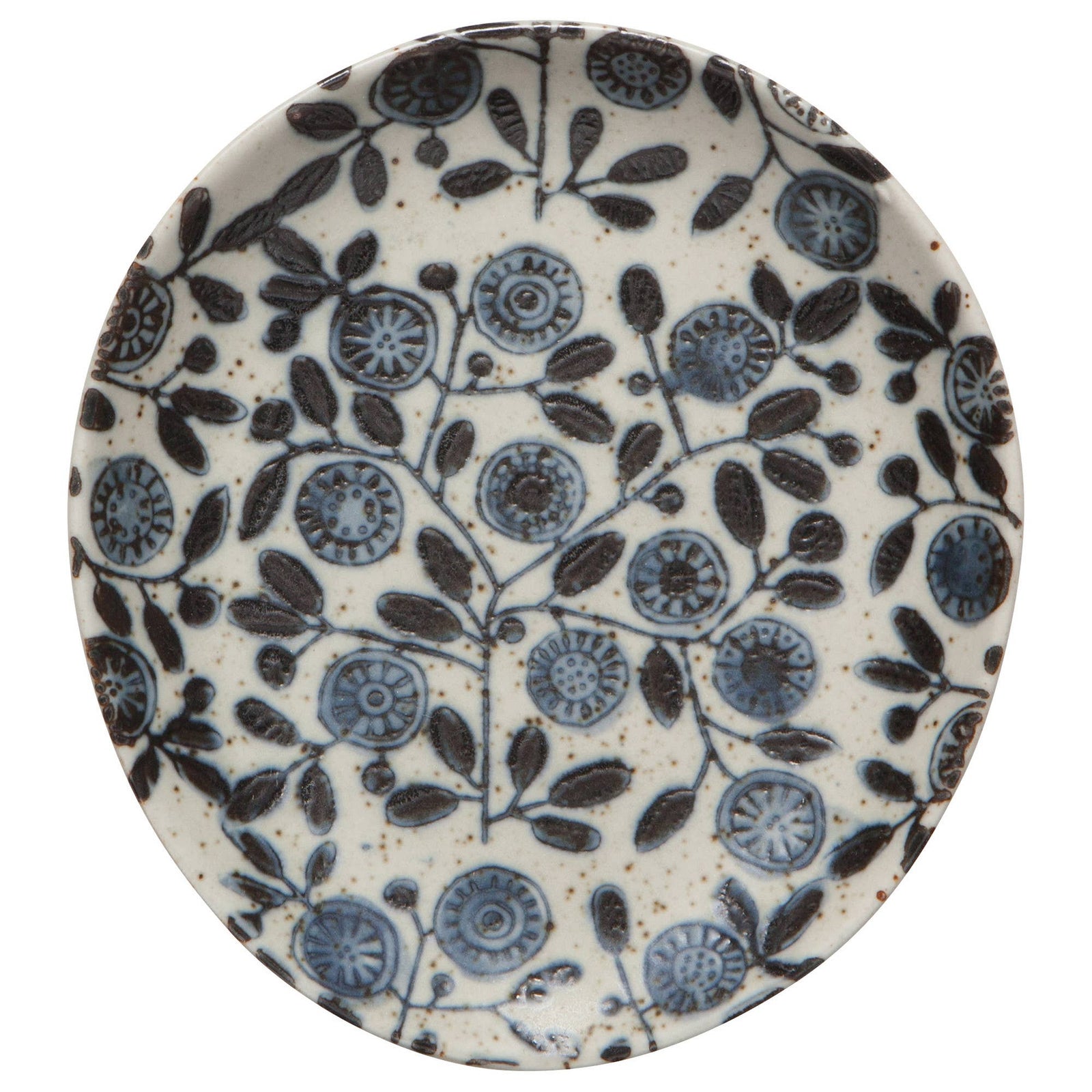 Ceramic plate with blue floral pattern next to a wooden spoon on a beige fabric background