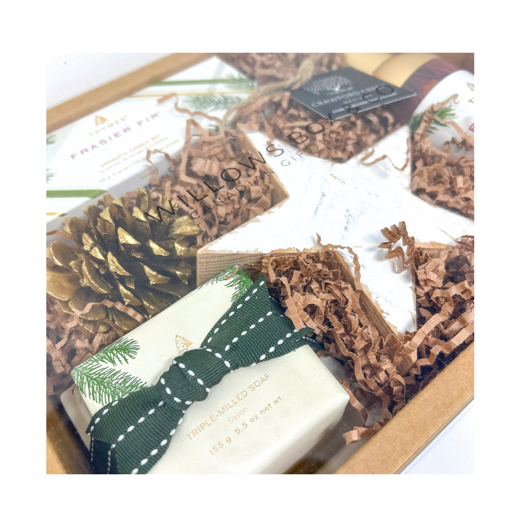 Gift set with a bottle of Frasier Fir candles, soap and roomspray, a box of tissues, and decorative elements in a kraft box.