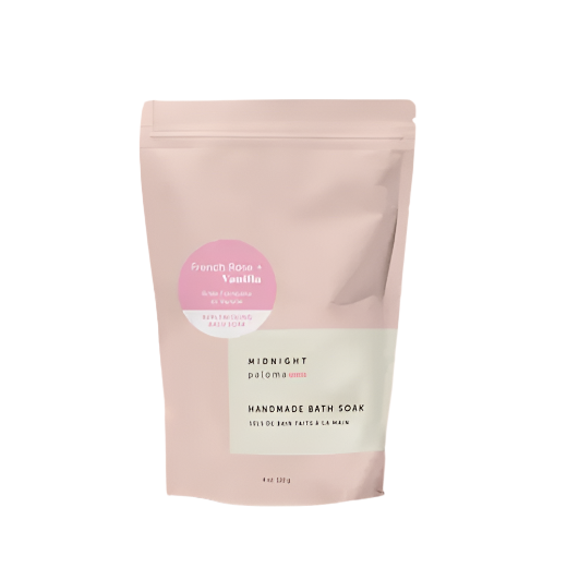 Handmade bath soap package with a pink label on a light pink background