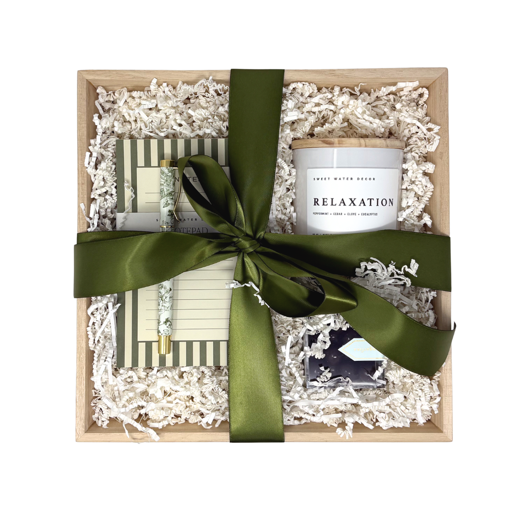 Notebook with green ribbon on a white textured surface