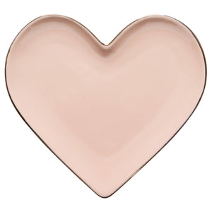 Heart-shaped pink ceramic plate on a white background
