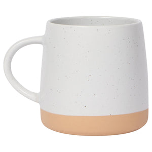 White speckled mug with a beige base on a white background