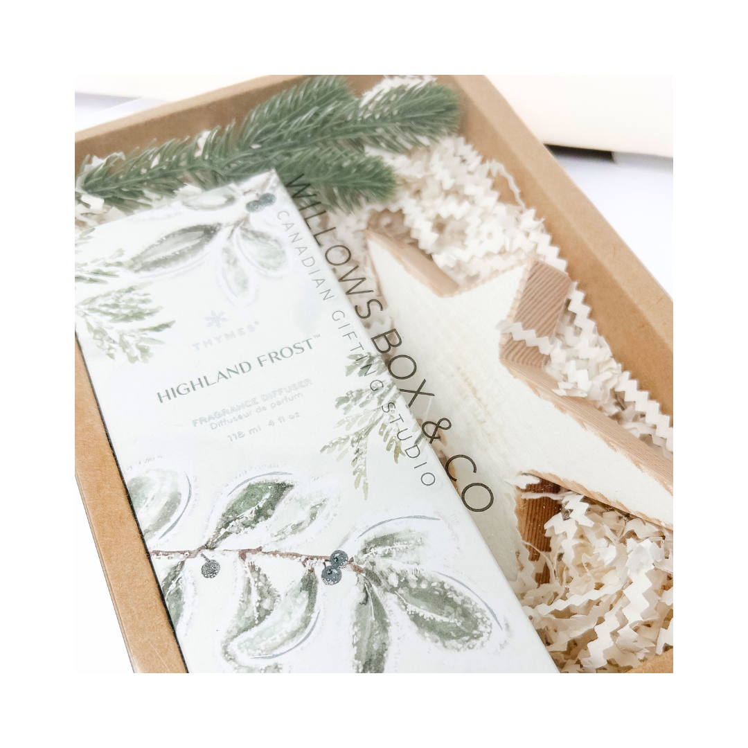 Gift set with star-shaped ornament, highland frost spray, and decorative elements in a kraft gift box.