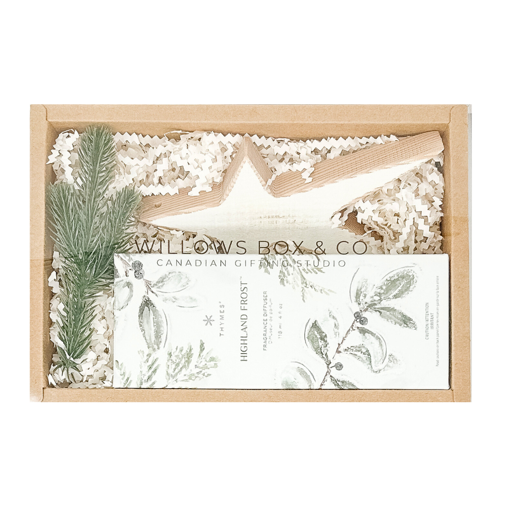 Gift set with star-shaped ornament, highland frost spray, and decorative elements in a kraft gift box.