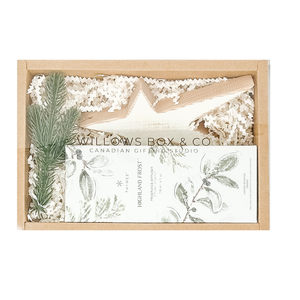 Gift set with star-shaped ornament, highland frost spray, and decorative elements in a kraft gift box.