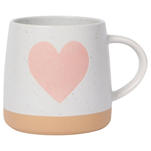 White mug with a pink heart design on a white background