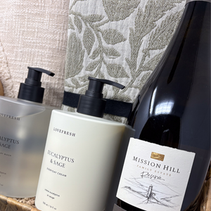 Bottle of Mission Hill Reserve wine with Lovefresh skincare products on a textured surface