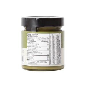 Jar of green spread with nutritional label on a white background