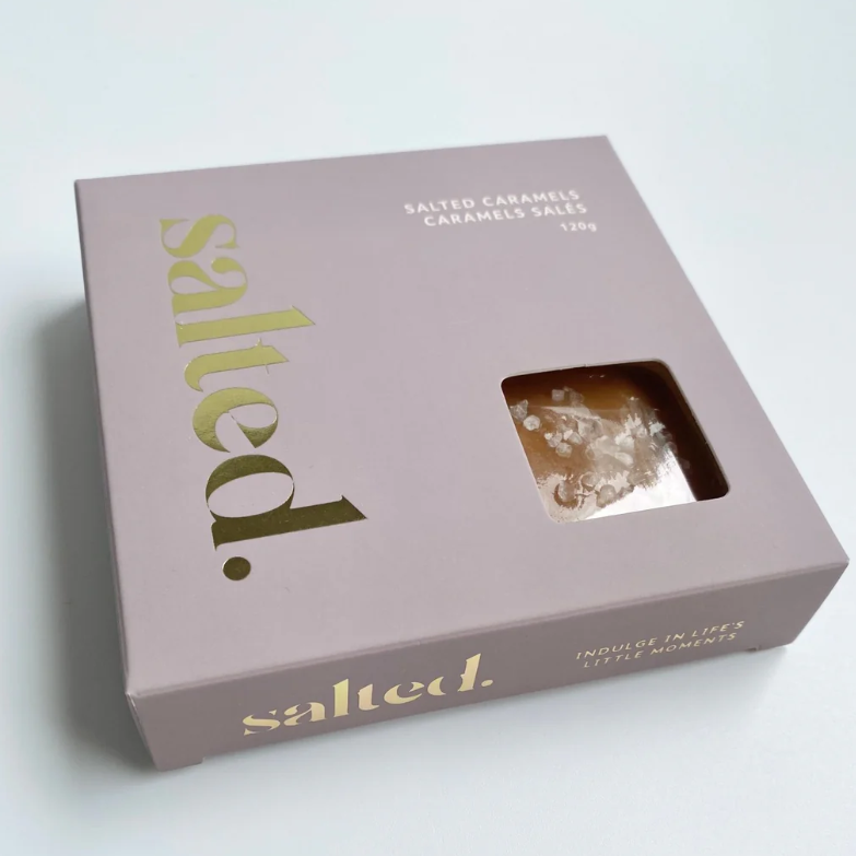Box of salted caramels with 'salted' branding on a light gray background