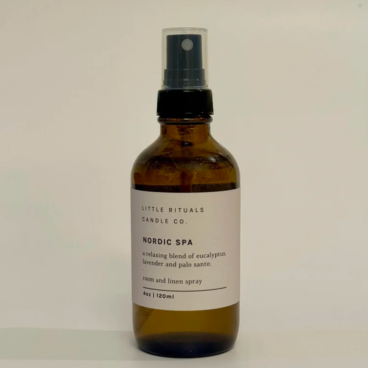 Brown spray bottle with label on a light beige background