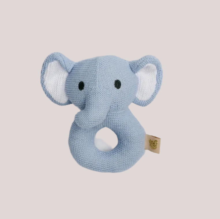 Knitted blue elephant rattle toy on a light gray background