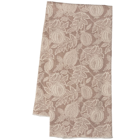 A rectangular fabric napkin or tea towel with a woven botanical pattern of pomegranates and leaves in a warm taupe-brown and cream colorway, shown against a plain white background.