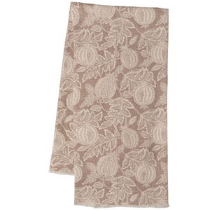 A rectangular fabric napkin or tea towel with a woven botanical pattern of pomegranates and leaves in a warm taupe-brown and cream colorway, shown against a plain white background.