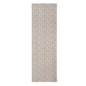 A long, narrow rectangular area rug with a dense, textured abstract pattern in shades of beige, gray, and off-white, shown against a plain white background.