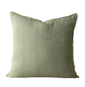 Green pillow with frayed edges on a white background