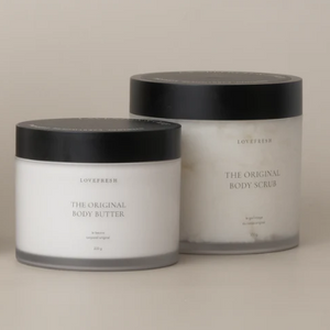 Two jars of 'The Original Body Scrub' on a beige background