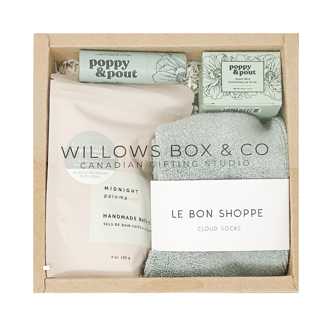 Box of bath products from Poppy & Pout, Midnight Paloma Bath, Cloud Socks in a gift box.