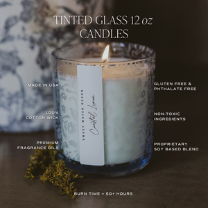 Tinted glass candle with a label on a dark background
