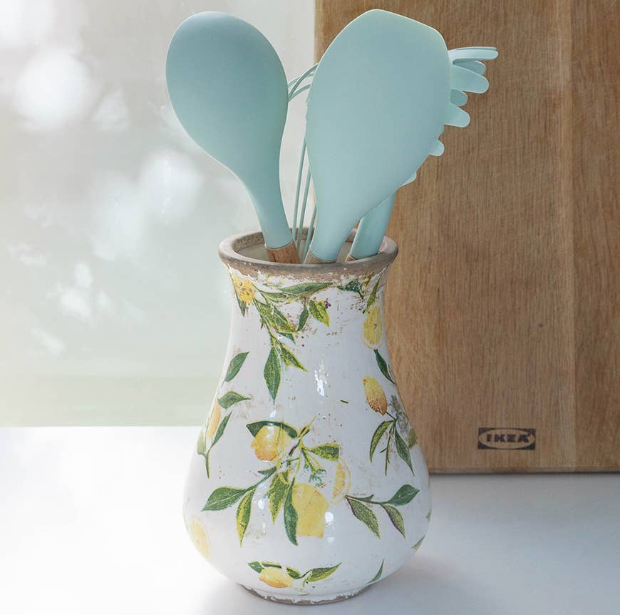 Ceramic vase with lemon and leaf pattern on a white background