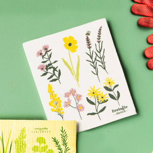 Gardening tools and plant identification cards on a green background
